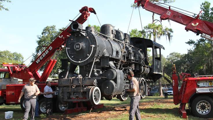 Webb's recovery cranes working together to lift a historic locomotive